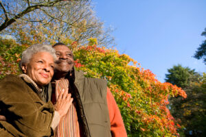 Senior,African,Couple,Hugging,Outdoors,On,A,Sunny,Autumn,Day.