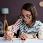 Portrait,Of,Teenage,Girl,With,Disability,Wearing,Glasses,And,Doing