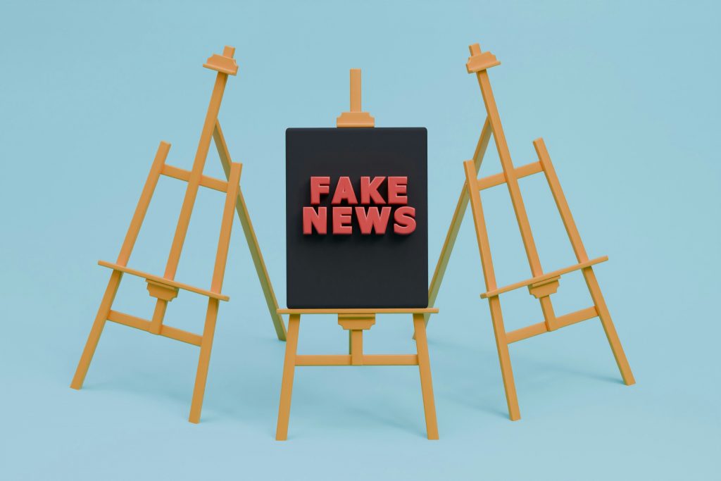 a fake news sign sitting on top of an easel